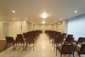a large room with chairs and a screen in it at MAG Hotels in Patna