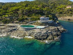 an aerial view of a house on a rocky island in the water at Capo d'Arco - Bougainvillea in Capo D'Arco
