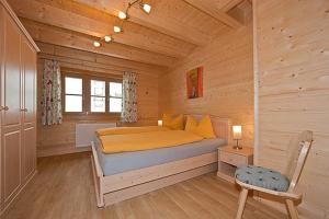 a bedroom with a bed in a wooden cabin at Harrys Chalet in Scharnitz