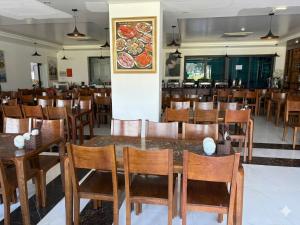 a dining room with wooden tables and chairs at MoonKing FLC Sầm Sơn in Sầm Sơn