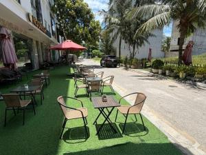 a row of tables and chairs on the side of a street at MoonKing FLC Sầm Sơn in Sầm Sơn