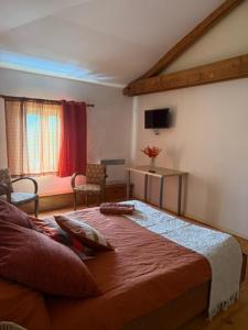 a bedroom with a bed and a living room at Petite champagne in Germignac