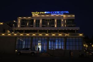 a building with a car parked in front of it at night at Nile View Hotels in Shirih