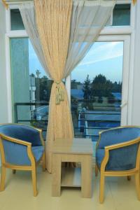 a room with a table and two chairs and a window at Nile View Hotels in Shirih