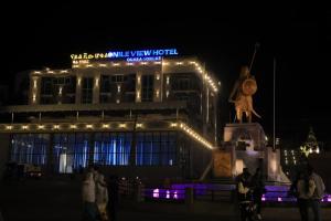 a building with a statue in front of it at night at Nile View Hotels in Shirih