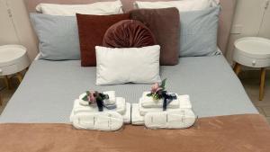 a bed with towels and dolls on top of it at Luxury Vatican Home - Private Garden in Rome +28 photos