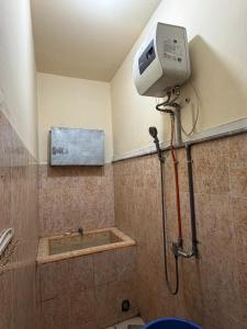 a shower in a bathroom with a shower at Villa Raisya Berastagi in Berastagi +10 photos