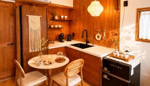 a kitchen with a small table and a sink at 한옥스테이 설화 in Gyeongju