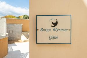 a sign on the side of a building at Borgo Myricae - Giglio in Chia