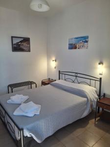 a bedroom with a bed with two towels on it at Villa Firostefani in Firostefani +81 photos