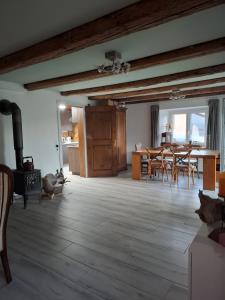 a living room with a table and a dining room at Maison mitoyenne avec terrasse in Asuel
