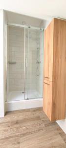 a bathroom with a shower with a glass door at Špulka Hideaway - Romantic Forest Escape near Prague in Teplýšovice
