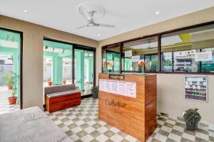 a lobby of a store with a bench and a counter at Super Collection O The Kailash Hotel in Dehradun +51 photos