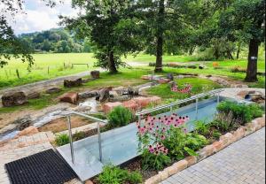 a garden with a swimming pool and flowers at Ferienwohnung Katzenberg in Bad Soden-Salmünster