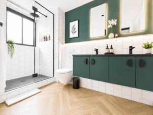 a bathroom with a green vanity and a shower at ZALS- Nine Palms -Luxury Two Bed in Cape Town +29 photos
