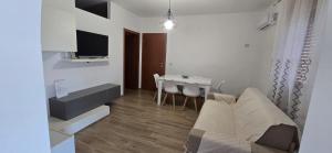 a living room with a couch and a table at Residence Canitano Casa Vacanze Giada & David in Scanzano