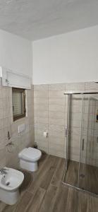 a bathroom with a toilet and a shower and a sink at Residence Canitano Casa Vacanze Giada & David in Scanzano +13 photos