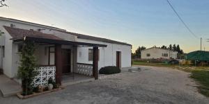 a small white house with a porch at Residence Canitano Casa Vacanze Giada & David in Scanzano