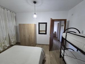 a bedroom with two bunk beds and a mirror at Residence Canitano Casa Vacanze Giada & David in Scanzano