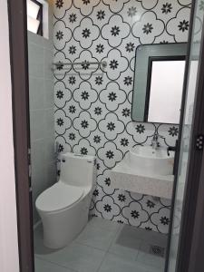 a bathroom with a toilet and a sink at Lumina Homes 2 Lai Xá in Thuong Thon