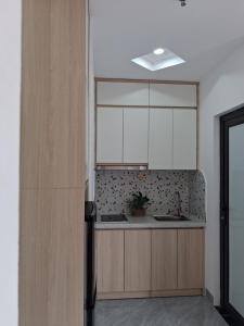 a kitchen with white cabinets and a sink at Lumina Homes 2 Lai Xá in Thuong Thon