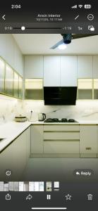 a kitchen with white cabinets and a stove top oven at JDs elite in Trivandrum
