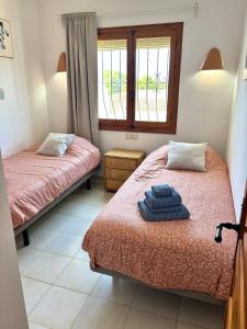 a room with two beds and a window at Amor Supremo in Cumbre del Sol