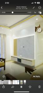a living room with a large tv on a wall at JDs elite in Trivandrum