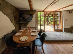 a dining room with a table and chairs and a window at Willa Hacienda in Międzybrodzie Żywieckie