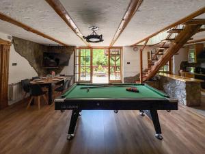 a room with a pool table in a house at Willa Hacienda in Międzybrodzie Żywieckie