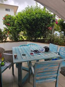 a wooden table with two chairs and a table at Oceanfront in Azuri in Roches Noires