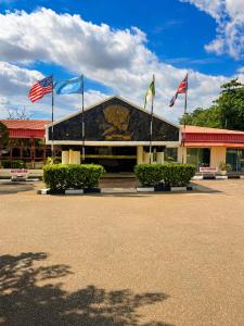 a building with three flags in front of it at Royalbirds Motel in Akure