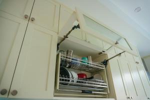 a kitchen cabinet with white cabinets with dishes at Luxury Mi-a Villa LaGi 4pn, huge salted pool, outdoor bbq and kara, up to 20 in Lagi +27 photos