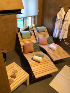 a group of wooden beds with pillows on them at Le Pot de Miel d'Ugny in Ugny