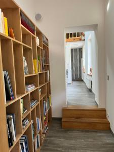 a hallway with wooden bookshelves in a house at Le Pot de Miel d'Ugny in Ugny