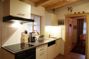 a kitchen with a sink and a stove top oven at Ferienwohnung Angerer in Stumm