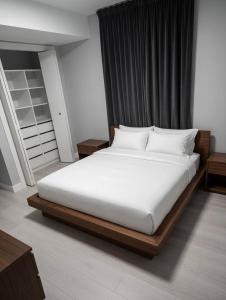 a bed with white sheets and pillows in a room at Sully House in Winnipeg