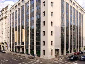 a tall white building on a city street at Mercure Lyon Centre Saxe Lafayette in Lyon