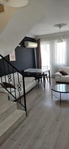 a living room with a staircase and a couch at Ng Hisar Apart Hotel in Fethiye