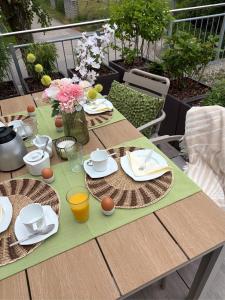 a wooden table with plates and cups on top of it at Fewo Sonnblick in Windsbach