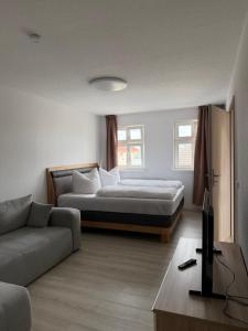 a living room with a bed and a couch at FeWo Augusta in Neustrelitz