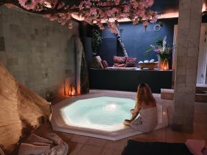 a woman sitting in a hot tub in a room at Axel Guldsmeden in Copenhagen