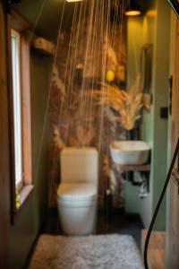 a bathroom with a toilet and a sink at Chill Out Carnikava in Carnikava
