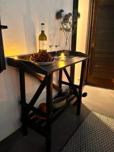 a table with a bottle of wine and wine glasses at Charming Casa Maria Pag in Pag