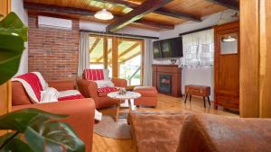 a living room with couches and a fireplace at Villa Velika by Villas Guide in Pisarovina