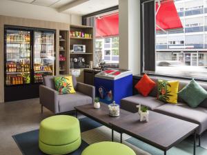 a living room with two couches and a coffee table at ibis Genève Centre Gare in Geneva