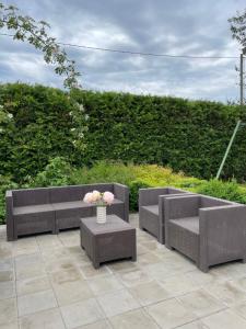 a patio with two chairs and a vase of flowers at Chill Out Carnikava in Carnikava