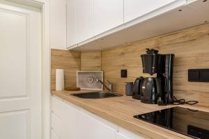 a kitchen counter with a sink and a coffee maker at Auszeit am Fluss - Donau in Obernzell