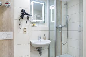 a bathroom with a sink and a shower at Auszeit am Fluss - Donau in Obernzell +27 photos