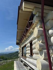 a log cabin with windows on the side of it at Садиба Сикитура in Verkhneye Vodyanoye